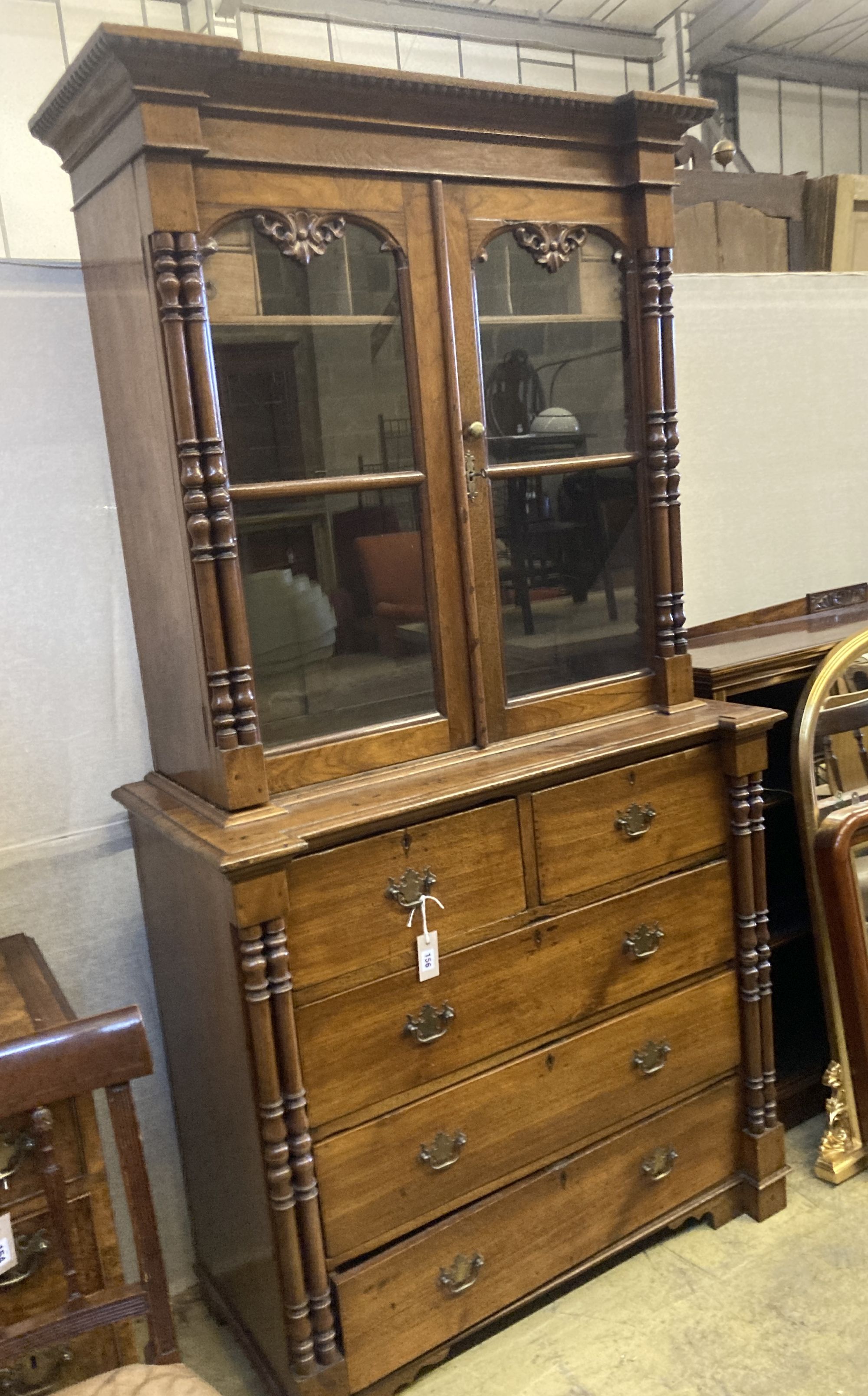 A 19th century Continental oak glazed cabinet on chest, width 104cm, depth 51cm, height 200cm